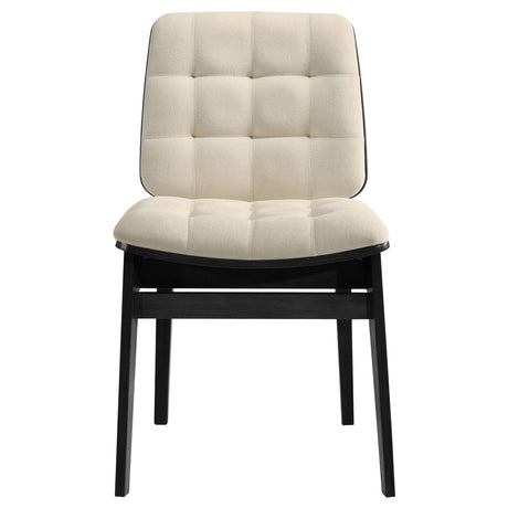 Side angle showing tapered black rubberwood legs and cream velvet seat