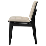 Detail of the black wood frame and tufted velvet upholstery