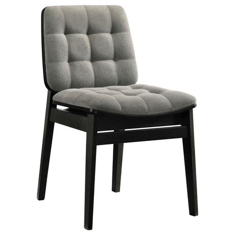 Side view of Redbridge chair showing channel-tufted velvet upholstery and tapered legs