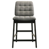 Close-up of the channel-tufted grey velvet seat and back on Redbridge counter chair