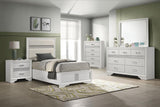 White upholstered twin bed viewed from footboard side