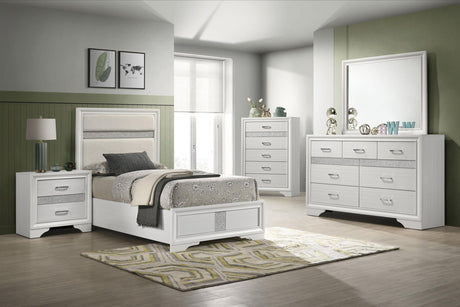 White upholstered twin bed viewed from footboard side