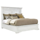 Close-up on ornate molding and recessed panels of McKinney bed