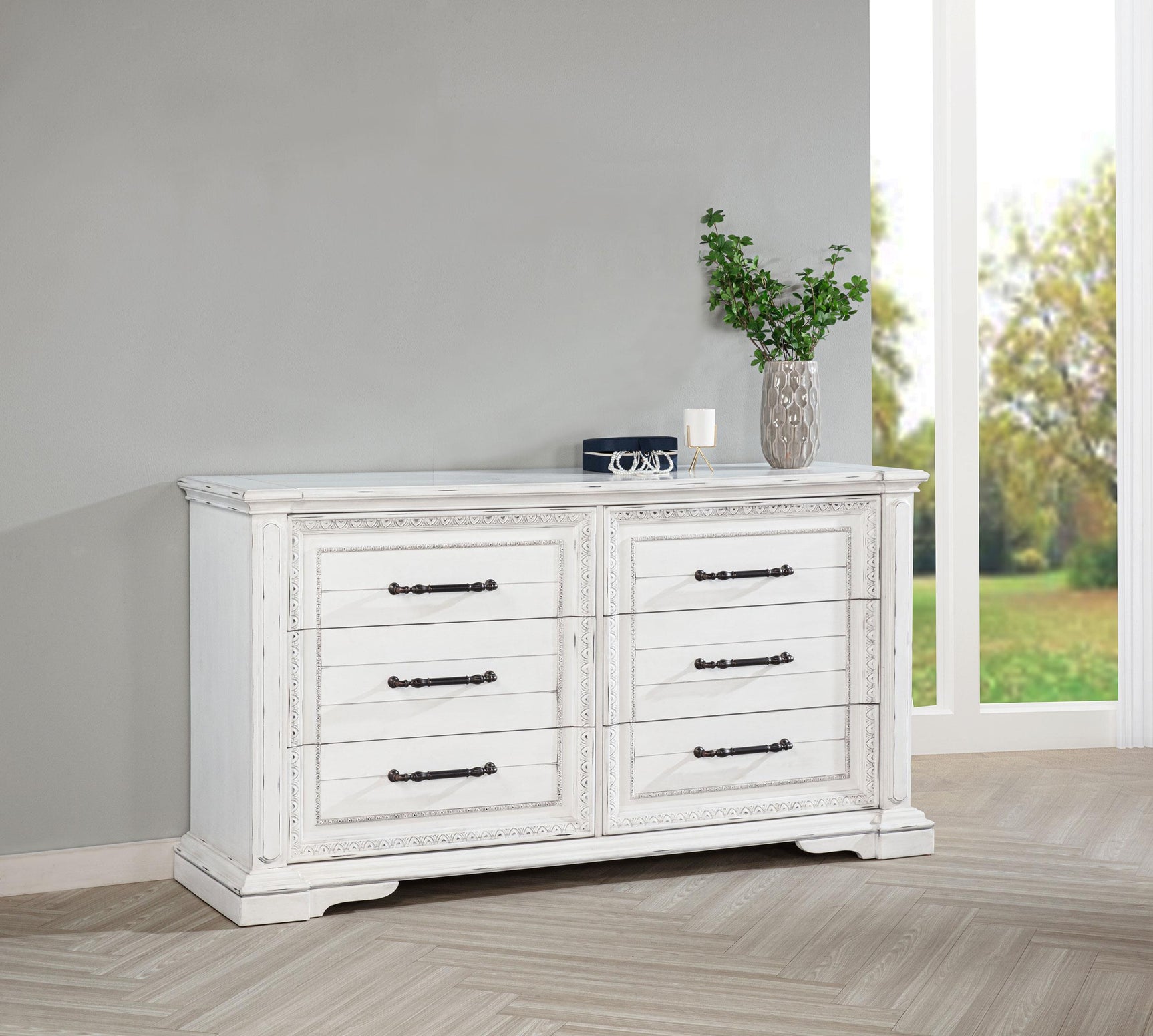 Detailed view of ornate trim and antique bronze drawer pulls