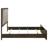 Bed frame corner showing fabric upholstery and wood joinery