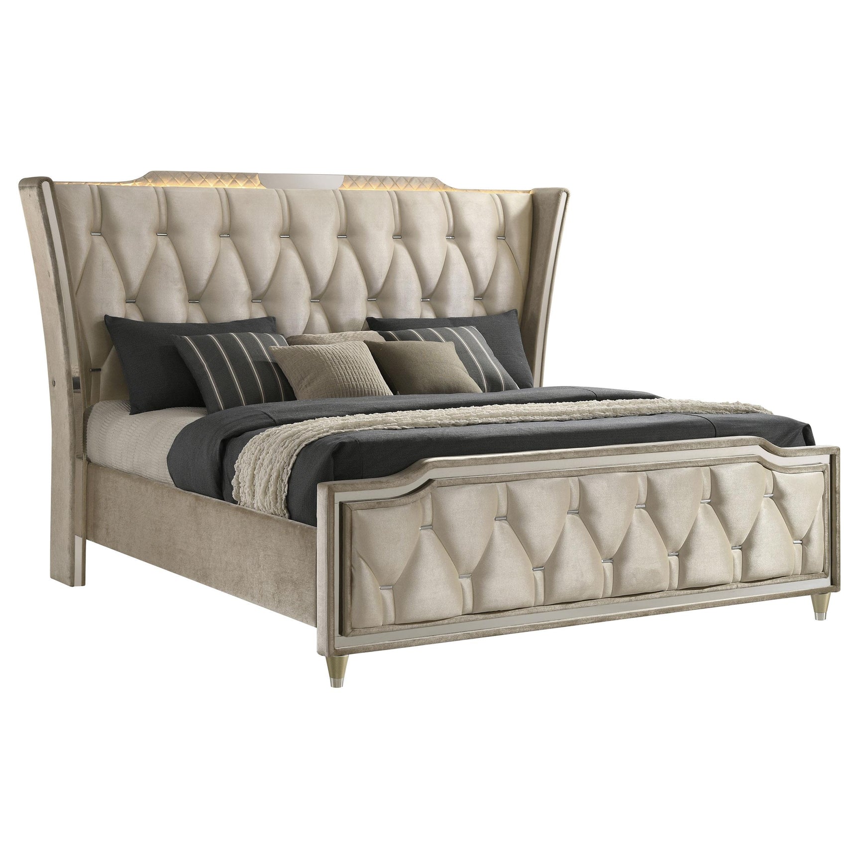 Close-up of wingback button-tufted headboard with ivory and camel velvet fabric