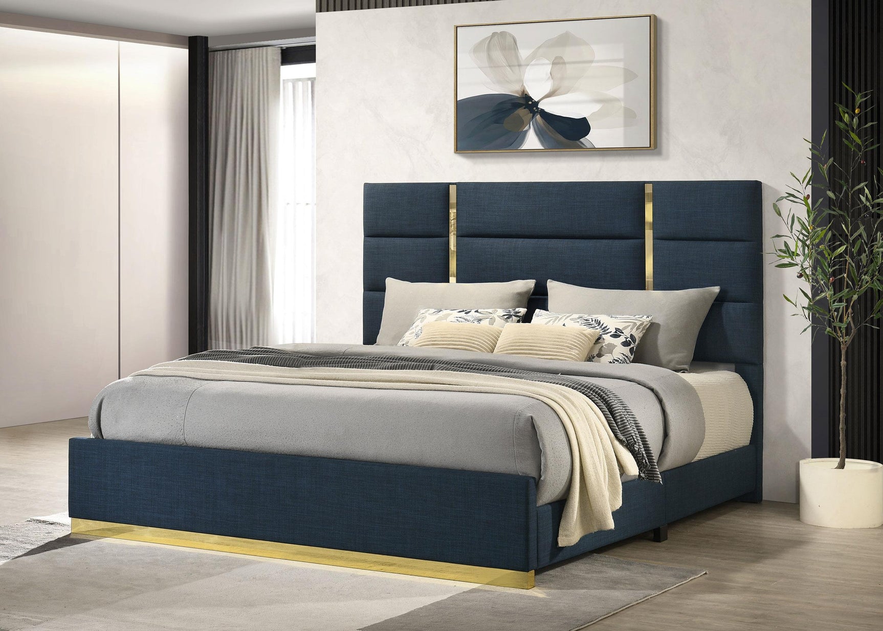 Ines bed side angle showing navy upholstery and gold headboard strips