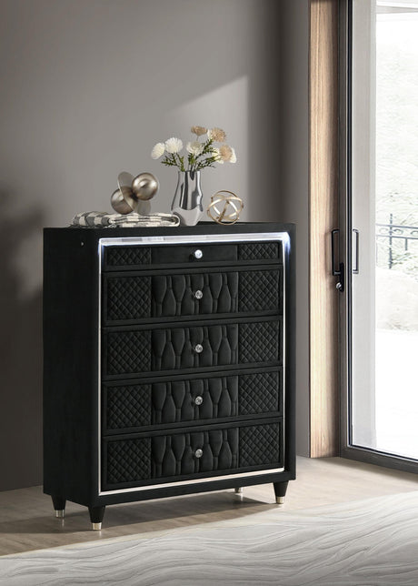 Close-up of crystal drawer knob and quilted velvet upholstery