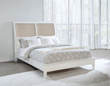 Side view of Bexhill 56-inch upholstered queen panel bed in white