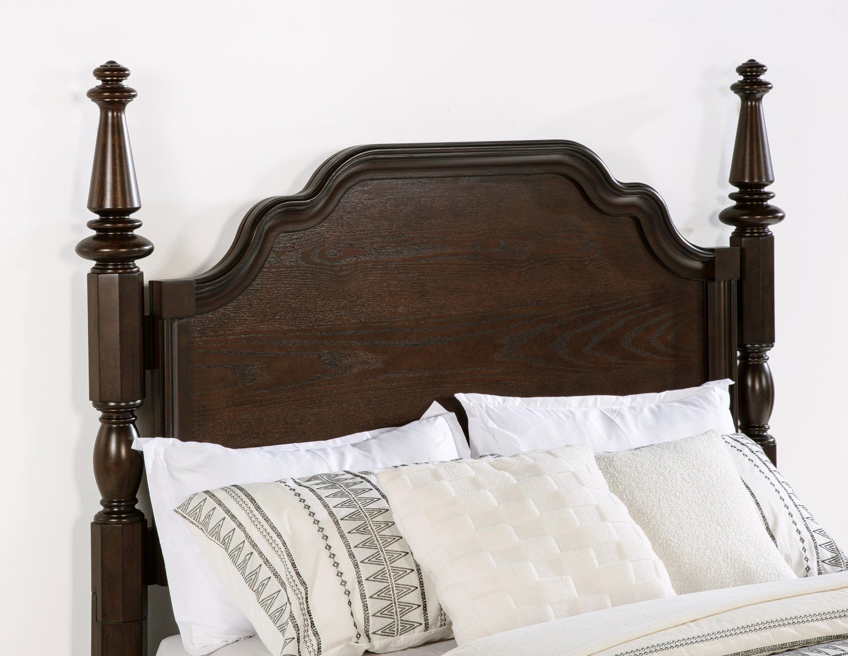 Close-up of dark oak finish and serpentine headboard