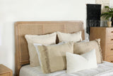 Side angle showing metal legs and cane panel on Arini Queen Panel Bed