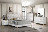Close-up of tufted headboard with gold button details