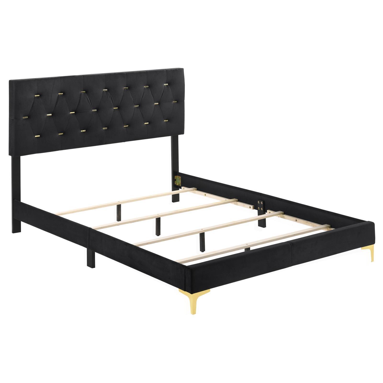 Gold metal bracket leg detail on black velvet bed frame