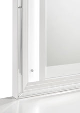 White framed dresser mirror in bedroom setting