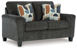 Erinslane Loveseat side view showing tapered faux wood legs