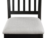 Close-up detail of Salvador set's black chair frame and light gray table surface