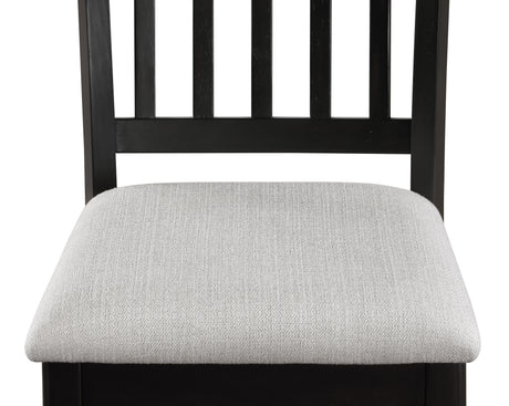 Close-up detail of Salvador set's black chair frame and light gray table surface