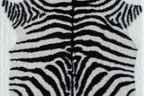Comfy Shag Black and White area rug angled on living room floor