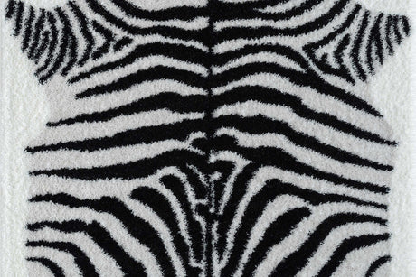 Comfy Shag Black and White area rug angled on living room floor