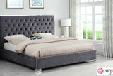Detailed shot of tufted cream velvet headboard with chrome hardware