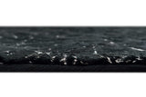 Side angle view of Rabbit Black and Silver rug on floor