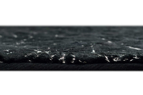 Side angle view of Rabbit Black and Silver rug on floor