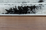 Side angle of Ivory shag rug showing thickness