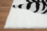 Black and white shag rug style displayed on wood floor