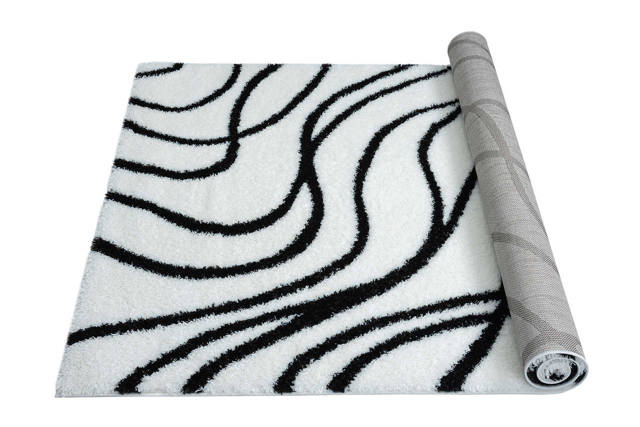 Soft shag ivory rug spread in cozy room