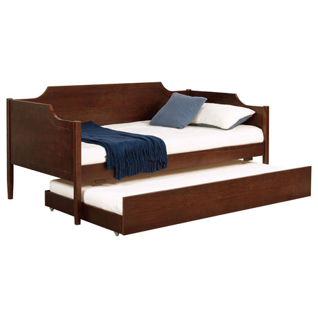 Pull-out trundle bed on wheels under the twin daybed