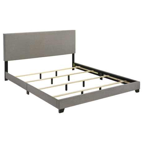 Dorian King Bed side angle showing fabric upholstery and legs