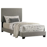 Close-up of the padded taupe fabric headboard