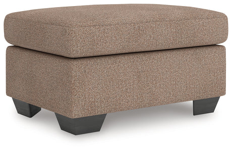Triston-Peaks Ottoman angled view showing upholstery and legs