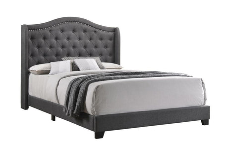 Side view showing tufted grey fabric and side storage drawers