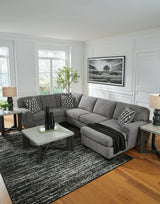 Close-up detail of gray chenille fabric on sectional sofa