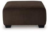Close-up of chocolate velvet upholstery and exposed faux wood feet