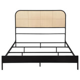 Detailed view of woven rattan headboard on black metal bed