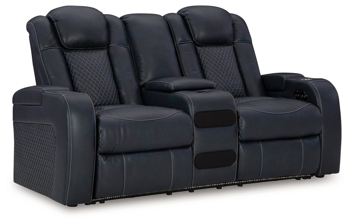 Close-up of cup holders and charging ports on sofa arm