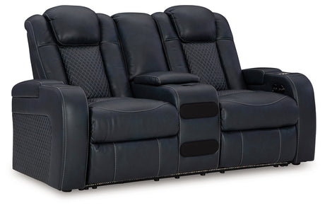 Close-up of cup holders and charging ports on sofa arm