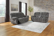 Close-up of pillow-wrapped armrest on charcoal sofa