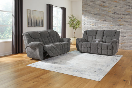 Close-up of pillow-wrapped armrest on charcoal sofa