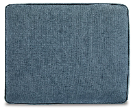 Detailed shot of ottoman upholstery in blue fabric