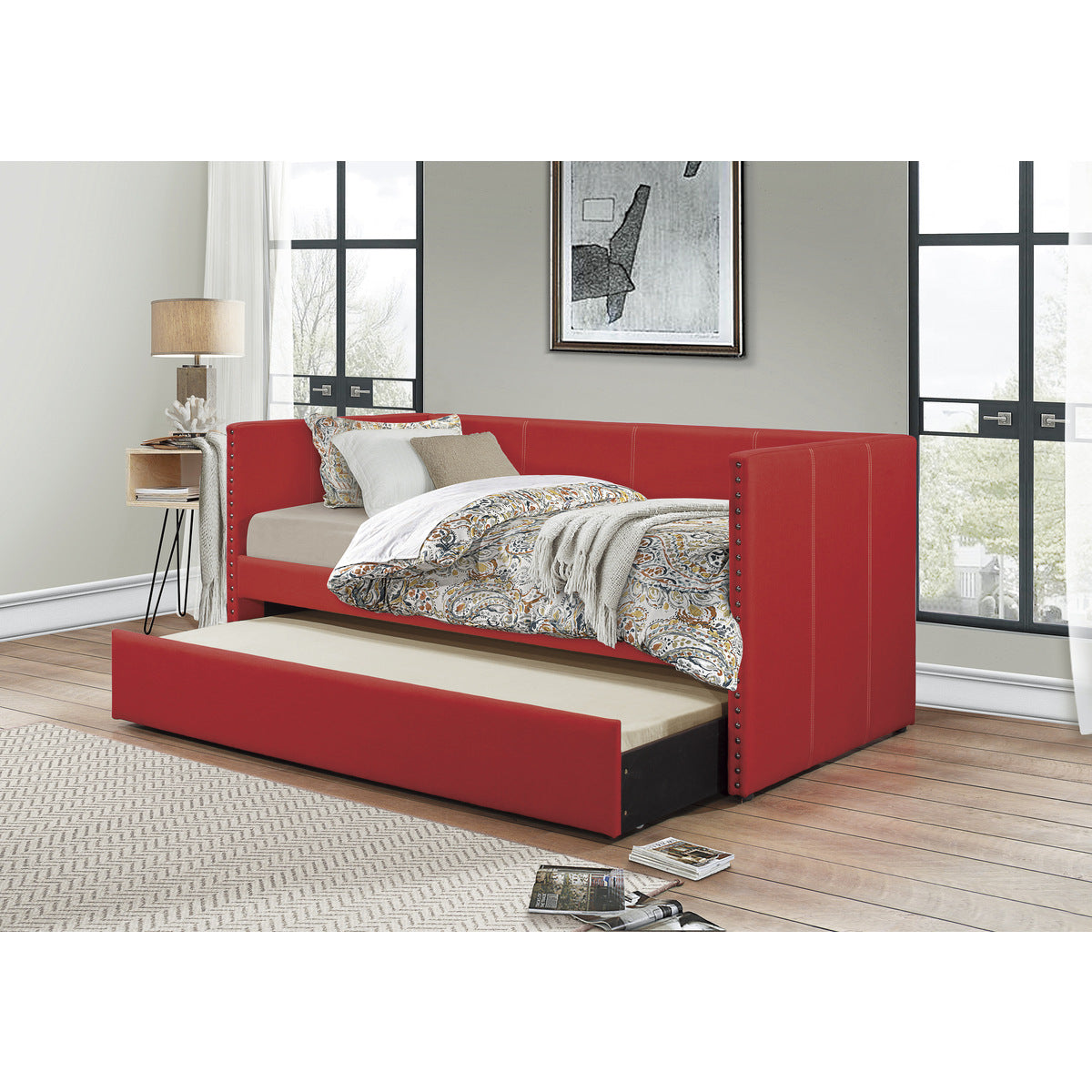 Open trundle bed beneath red daybed