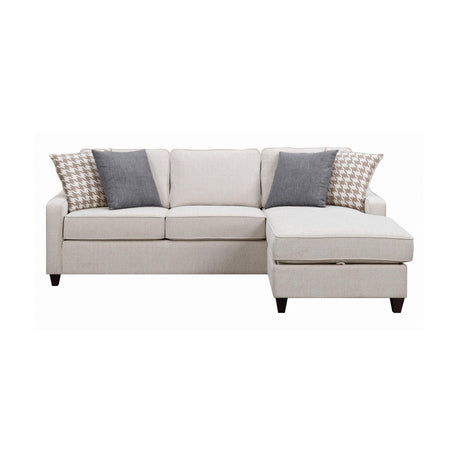 Detail view of cream fabric upholstery on sectional sofa