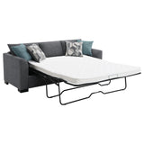 Grey fabric upholstery detail on sectional chaise