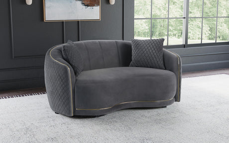 Side profile of Brookside dark grey velvet curved loveseat with gold trim