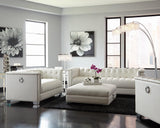 Close-up of the diamond tufted pearl white upholstery on ottoman