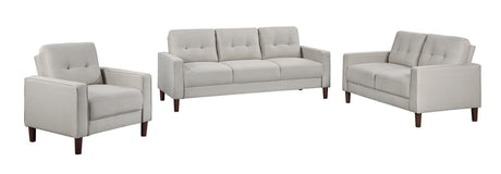 Beige upholstered loveseat with tufted back and track arms, front view