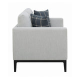 Side view of Apperson light grey loveseat with plaid pillows