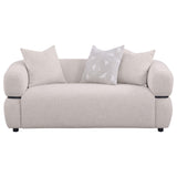 Jeanette loveseat side angle showing curved frame and wood waistband
